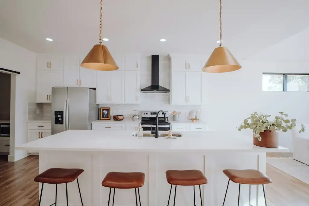 Bright kitchen with pendant lights hanging over a center island